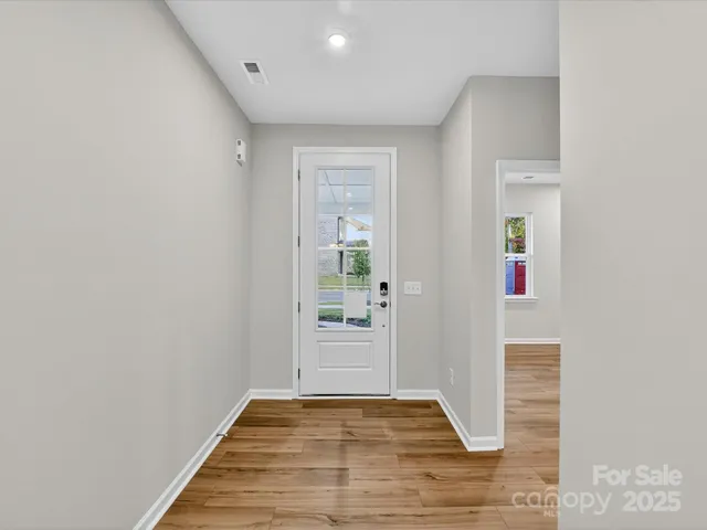 a view of hallway with wooden floor