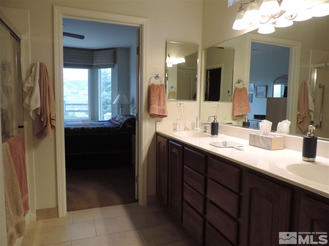 9142 Mount Pleasant Drive Reno, NV 89523 - Photo 11 of 34 a bathroom with a double vanity sink and a mirror