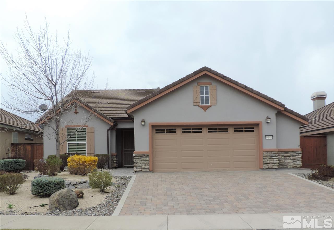 9142 Mount Pleasant Drive Reno, NV 89523 - Photo 17 of 34 a front view of a house with a yard and garage