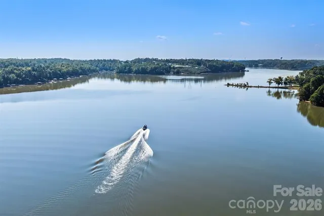 a view of a lake with houses in the back