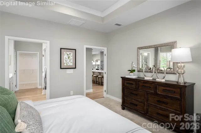 a bedroom with a bed and dresser with mirror