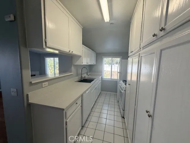 a kitchen with stainless steel appliances a refrigerator and microwave
