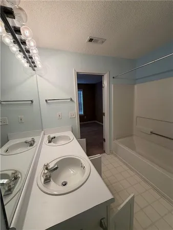 a bathroom with a sink a toilet and bathtub