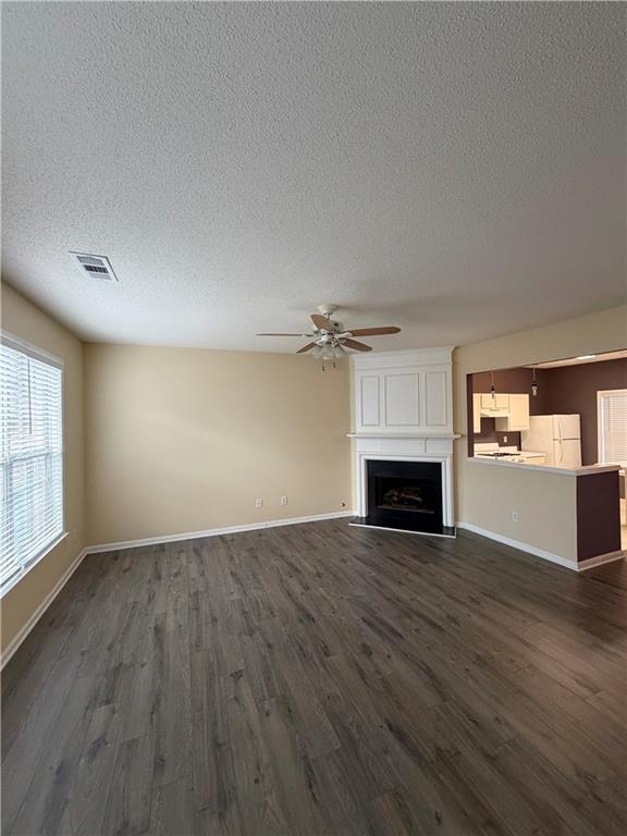 3722 Berkeley Crossing Duluth, GA 30096 - Photo 3 of 15 an empty room with windows fireplace and wooden floor
