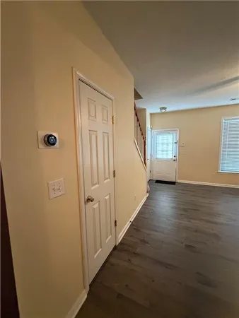 a view of a livingroom with wooden floor and stairs