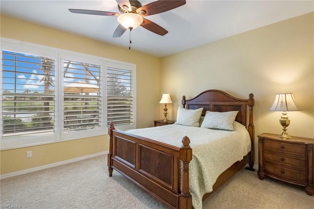 5857 Constitution Street Ave Maria, FL 34142 - Photo 13 of 40 a bedroom with a bed and a chandelier