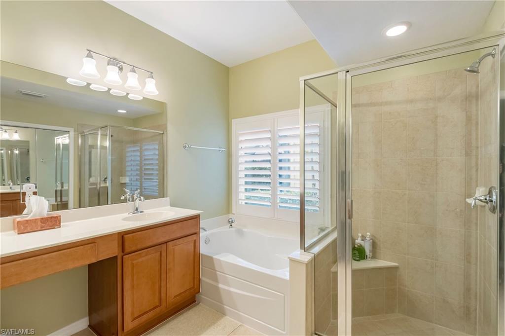 5857 Constitution Street Ave Maria, FL 34142 - Photo 15 of 40 a bathroom with a double vanity sink mirror and shower