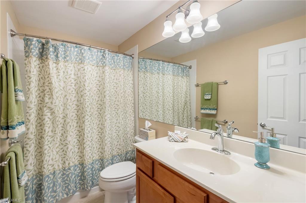 5857 Constitution Street Ave Maria, FL 34142 - Photo 18 of 40 a bathroom with a sink vanity mirror and toilet