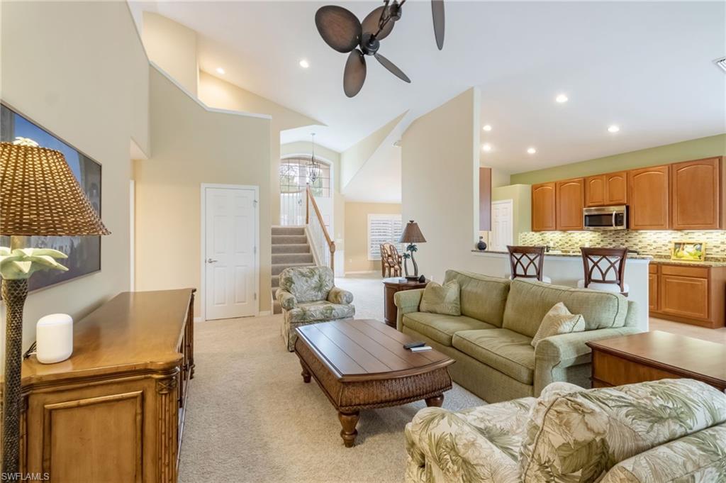 5857 Constitution Street Ave Maria, FL 34142 - Photo 5 of 40 a living room with furniture kitchen view and a wooden floor