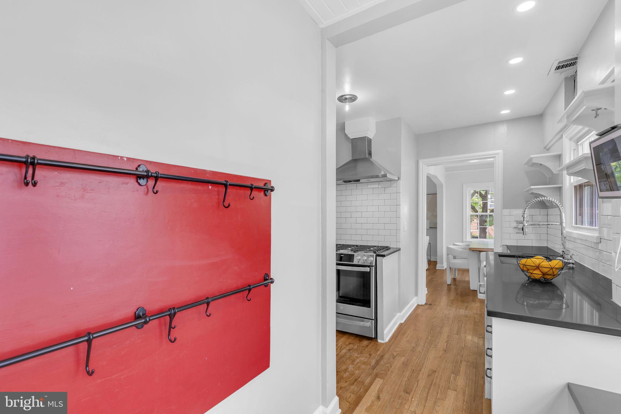 8603 Cedar Street Silver Spring, MD 20910 - Photo 11 of 46 a kitchen with granite countertop a refrigerator and a stove top oven