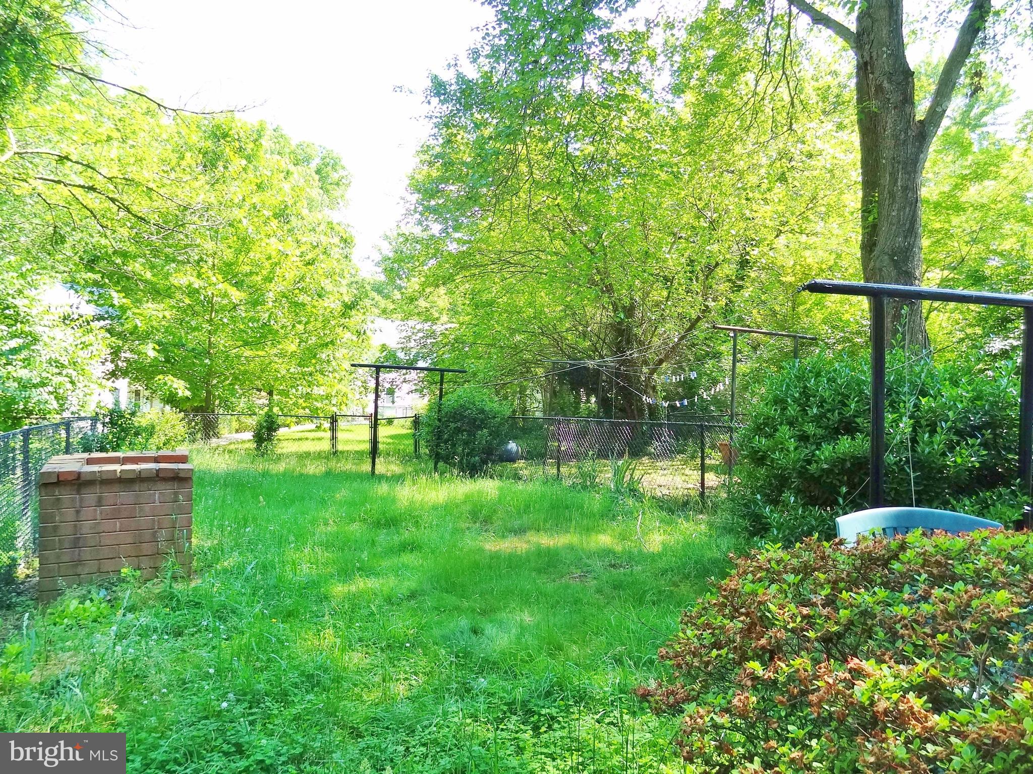 Fenced backyard with BBQ
