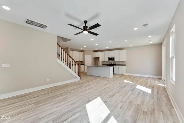 a view of kitchen with microwave and wooden floor