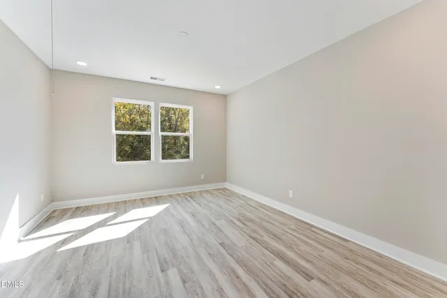 a view of an empty room and wooden floor