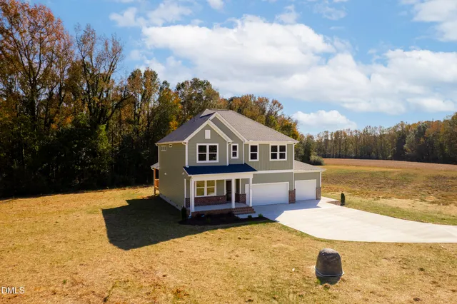 a sign of golf club on a wall under a tree