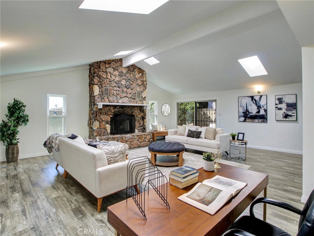 17815 Lysander Drive Carson, CA 90746 - Photo 13 of 24 a living room with furniture a fireplace and potted plants