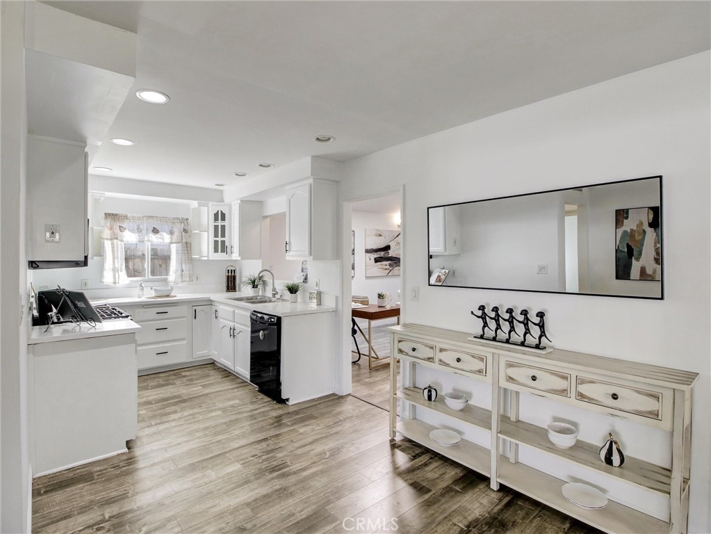 17815 Lysander Drive Carson, CA 90746 - Photo 7 of 24 a room with kitchen island white cabinets and stainless steel appliances