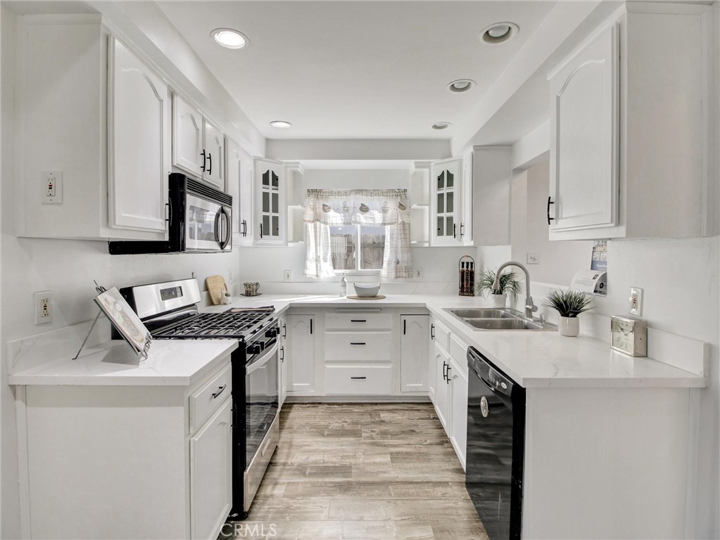 17815 Lysander Drive Carson, CA 90746 - Photo 9 of 24 a kitchen with a sink stove and cabinets