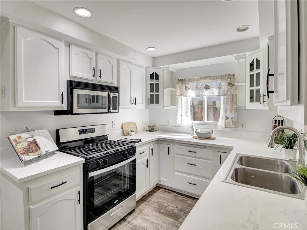 17815 Lysander Drive Carson, CA 90746 - Photo 10 of 24 a kitchen with granite countertop a sink stove and cabinets