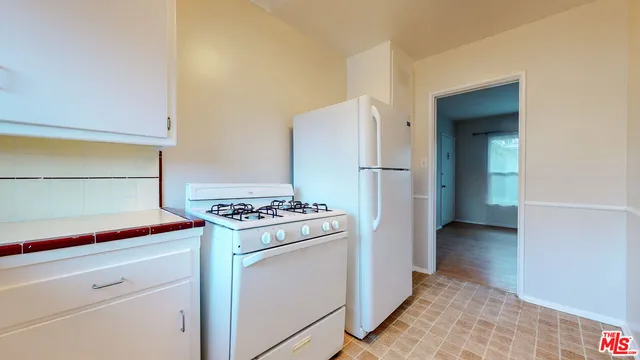 a kitchen with a stove and a refrigerator