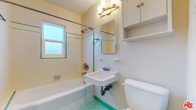 a bathroom with a sink a toilet and bathtub