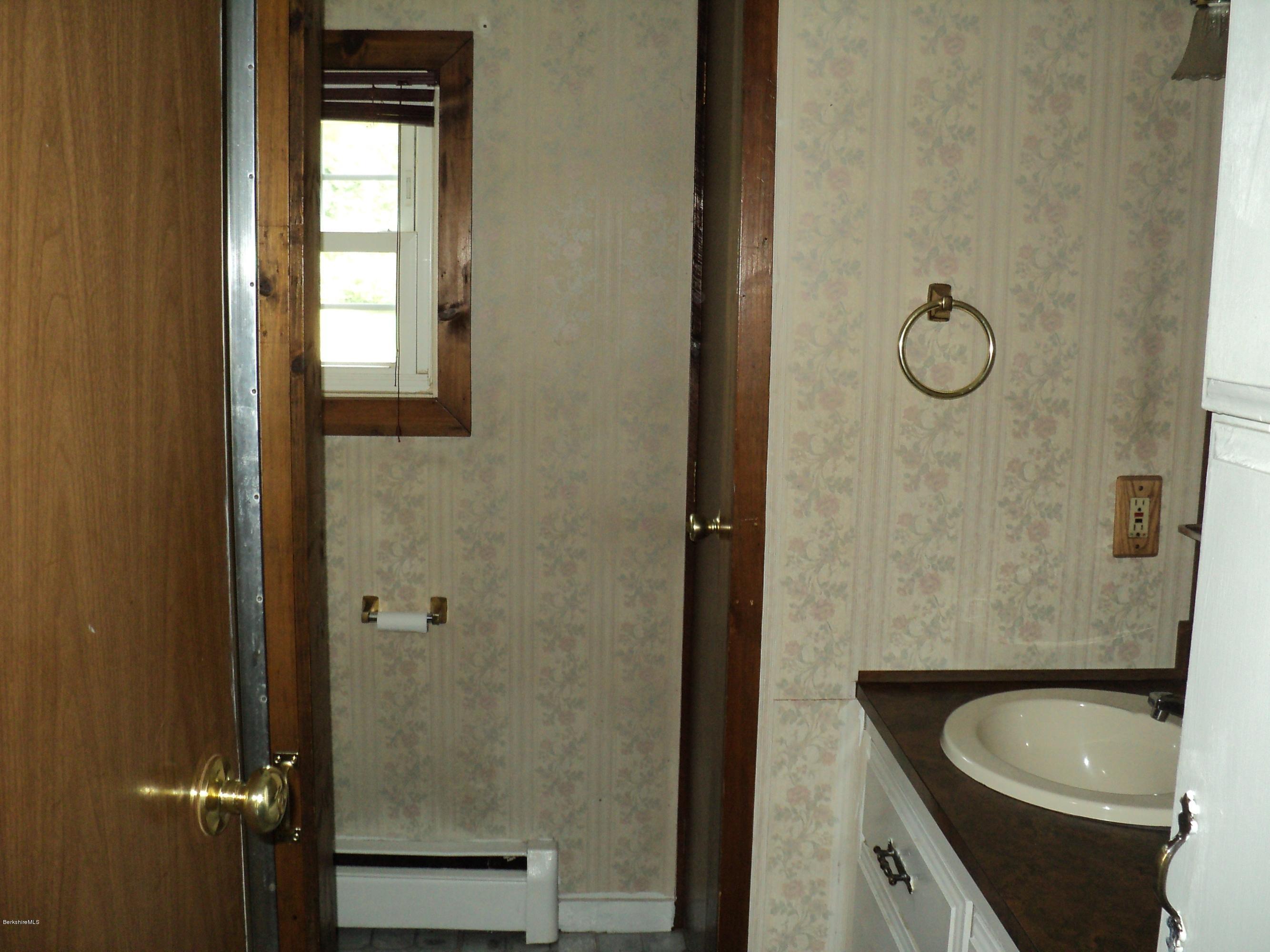 135 Tyringham Road Lee, MA 01238 - Photo 18 of 19 a bathroom with a granite countertop toilet sink and shower