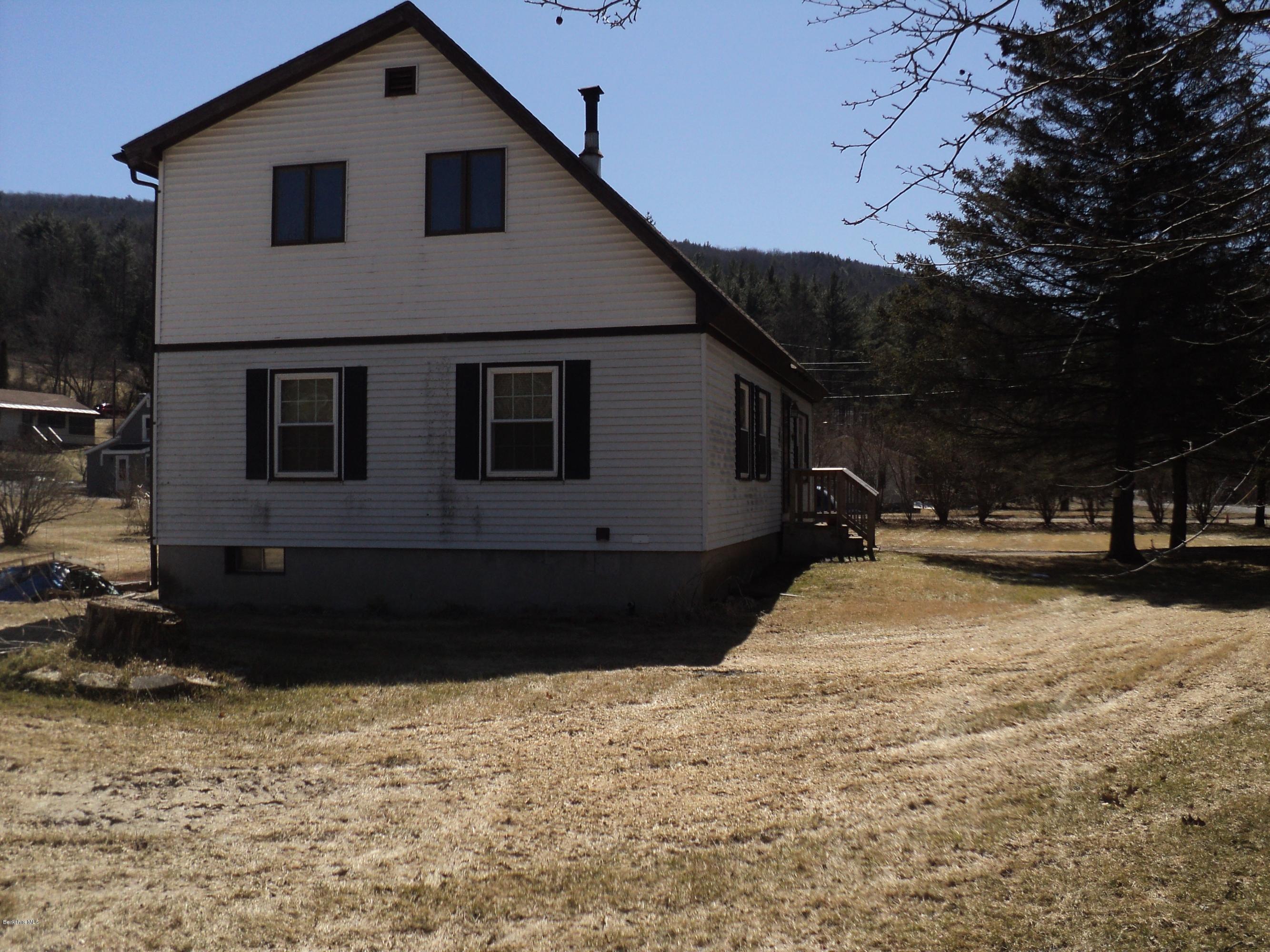 135 Tyringham Road Lee, MA 01238 - Photo 3 of 19 a front view of a house with a yard