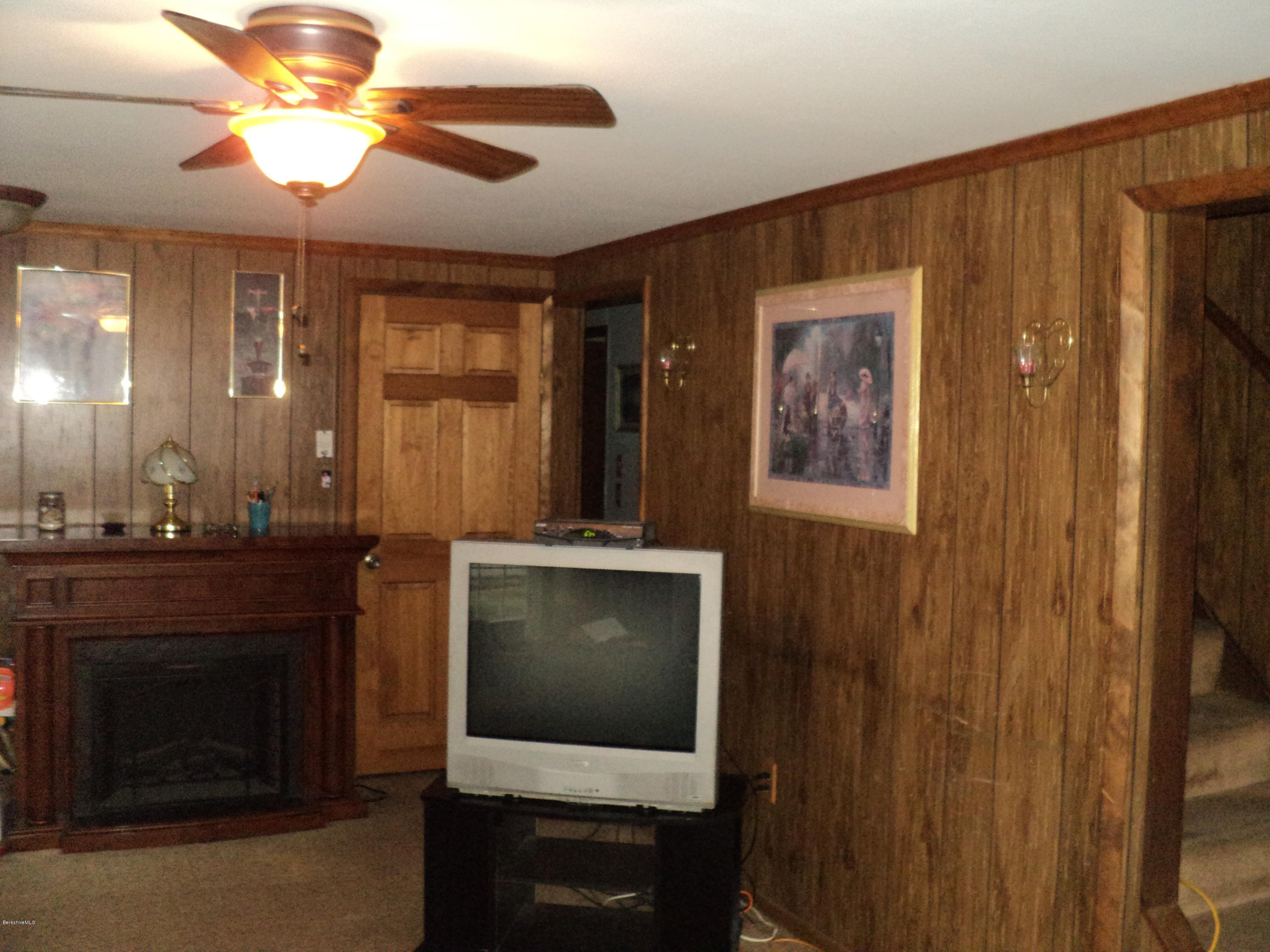 135 Tyringham Road Lee, MA 01238 - Photo 6 of 19 a living room with furniture and a fireplace
