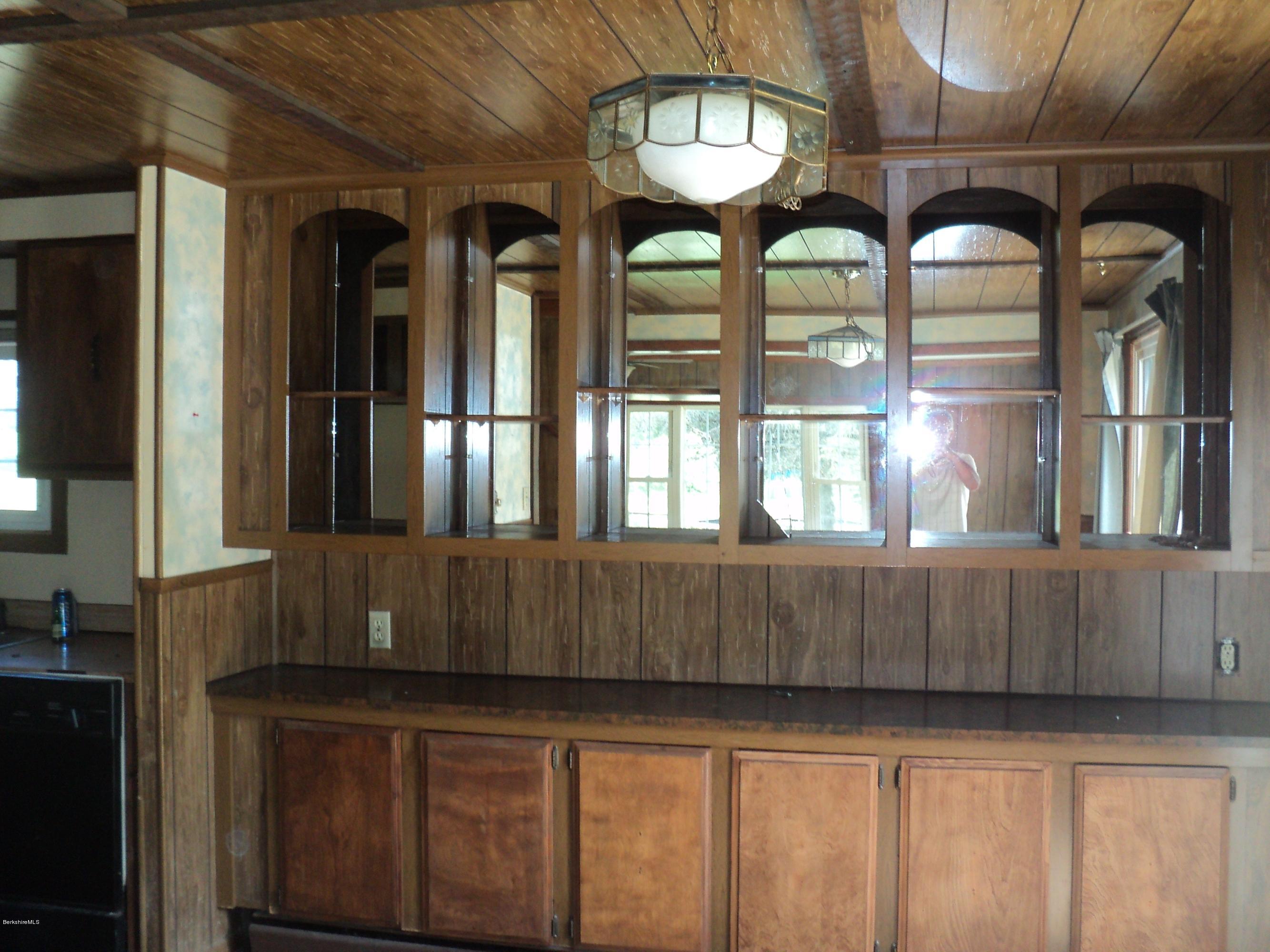 135 Tyringham Road Lee, MA 01238 - Photo 10 of 19 a large kitchen with a large window and chandelier