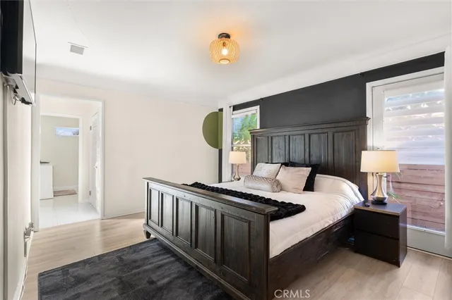 a bed sitting in a bedroom next to a window