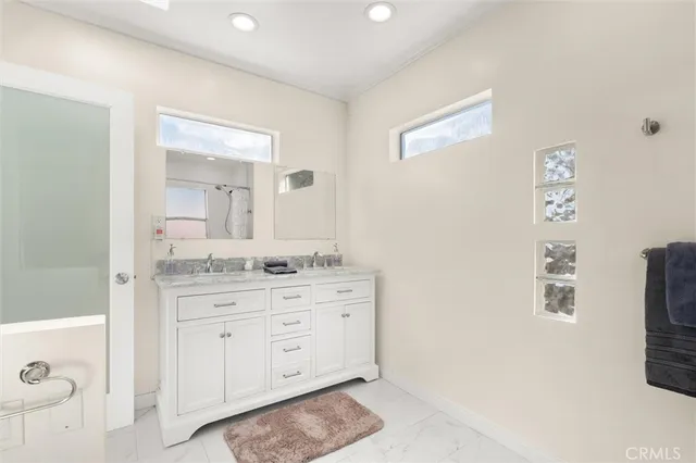 a bathroom with a granite countertop sink mirror and a