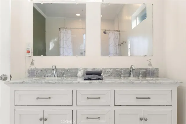a bathroom with a sink vanity and mirror