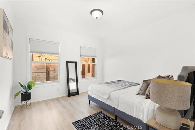 a bedroom with a bed and wooden floor