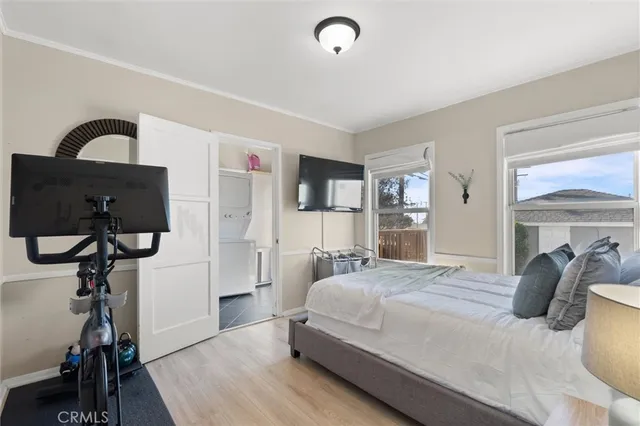 a bedroom with a bed and a wooden floor