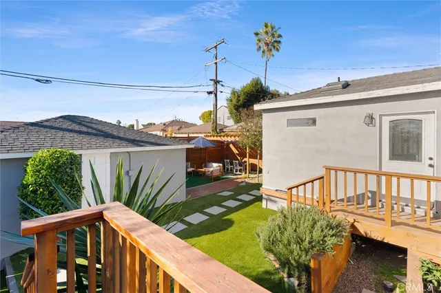 a view of a house with backyard and deck