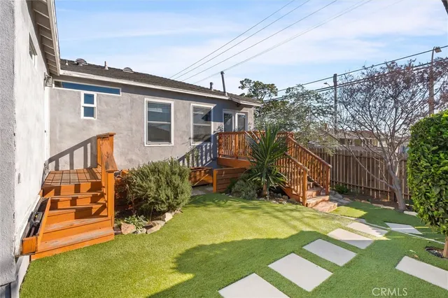 a view of a backyard with plants and a patio
