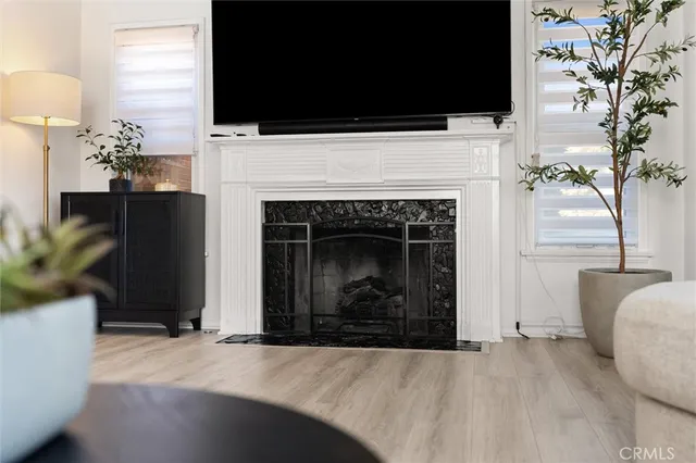 a living room with a fireplace and a flat screen tv
