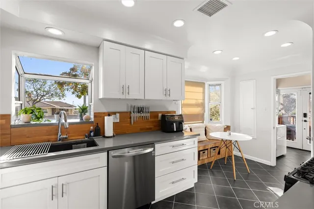a kitchen with sink cabinets and window