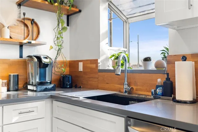 a kitchen with a sink and a potted plant