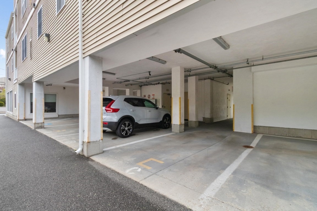 29 Spruce Street, Unit 23 Waltham, MA 02453 - Photo 26 of 26 a view of a parking space and a car park in front of it