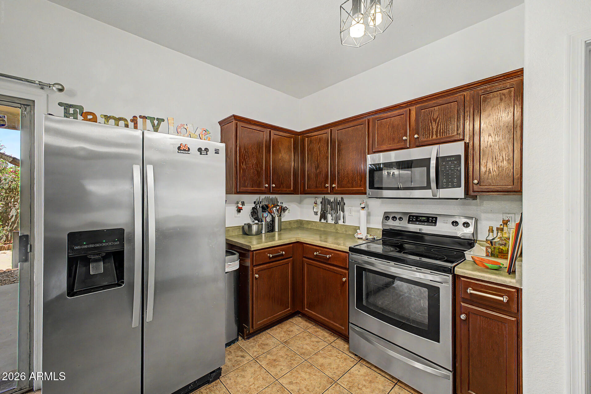 9730 West Payson Road Tolleson, AZ 85353 - Photo 13 of 57 a kitchen with granite countertop a refrigerator stove and microwave