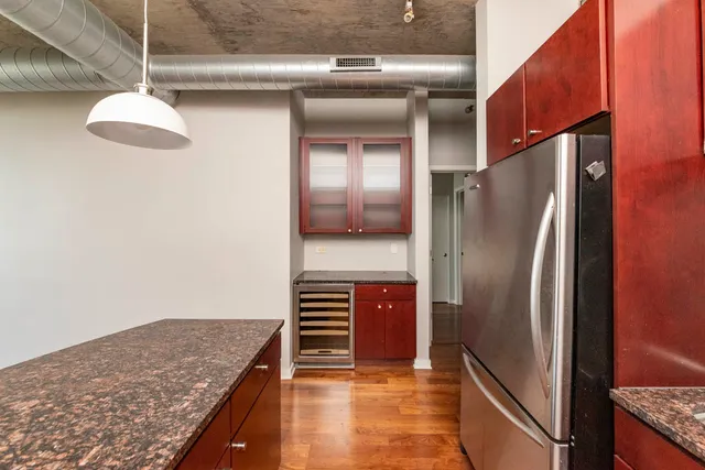 a kitchen with stainless steel appliances granite countertop a refrigerator and a stove