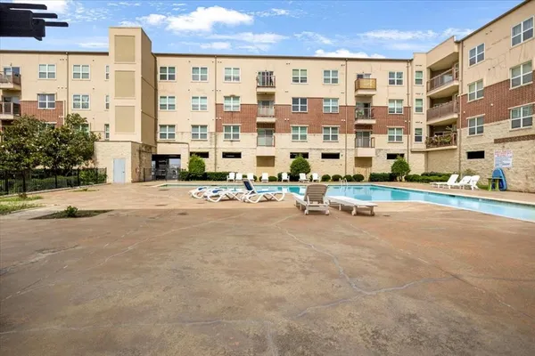 a view of tall building with a yard