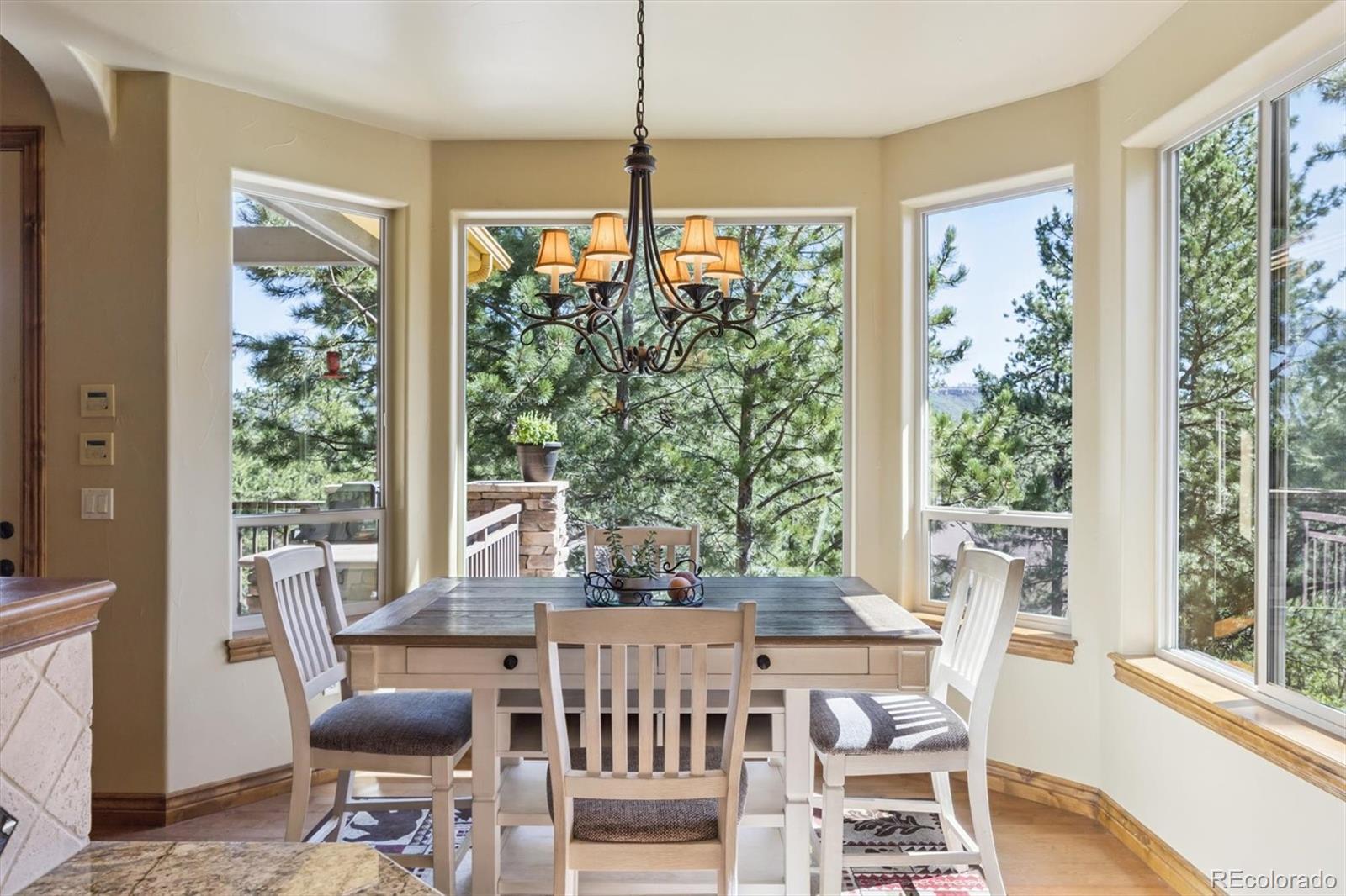 7994 Monarch Road Larkspur, CO 80118 - Photo 11 of 48 a view of a dining room with furniture window and outside view