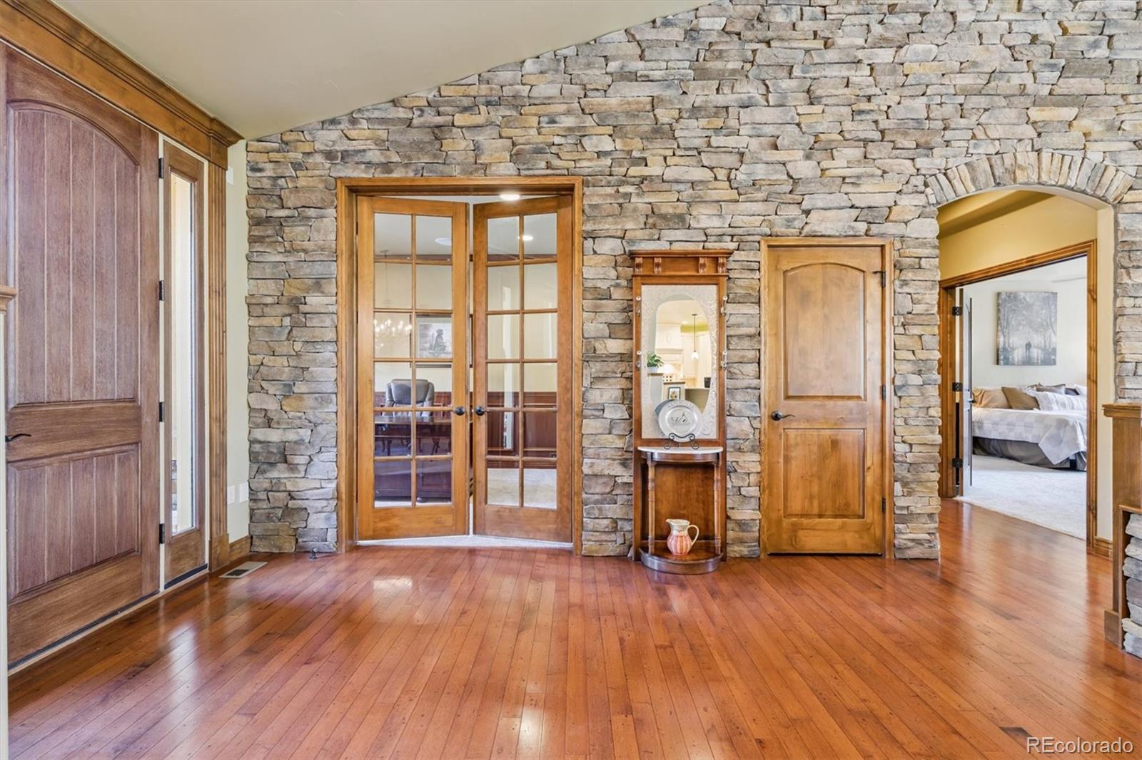 7994 Monarch Road Larkspur, CO 80118 - Photo 12 of 48 a view of a livingroom with wooden floor and furniture