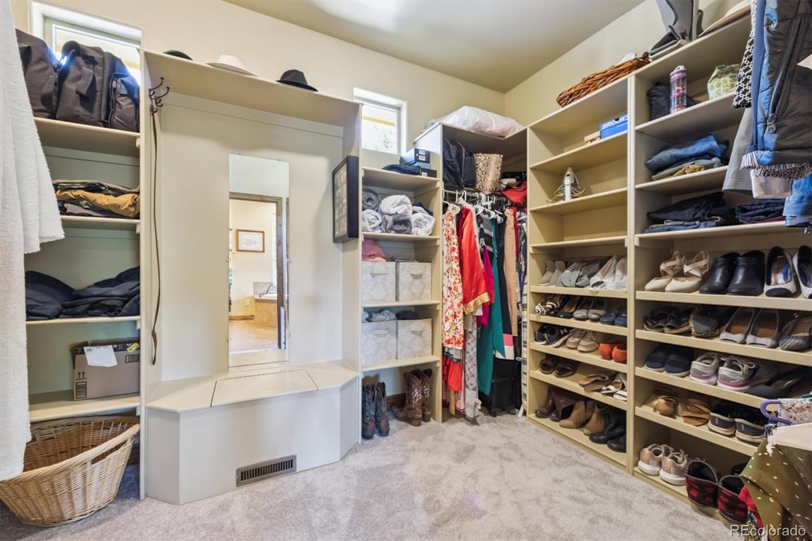 7994 Monarch Road Larkspur, CO 80118 - Photo 18 of 48 a view of walk in closet with clothes and shoes