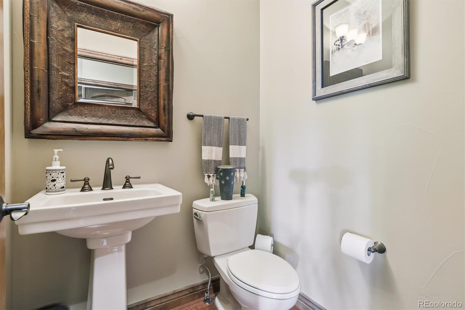 7994 Monarch Road Larkspur, CO 80118 - Photo 19 of 48 a bathroom with a toilet a sink and mirror