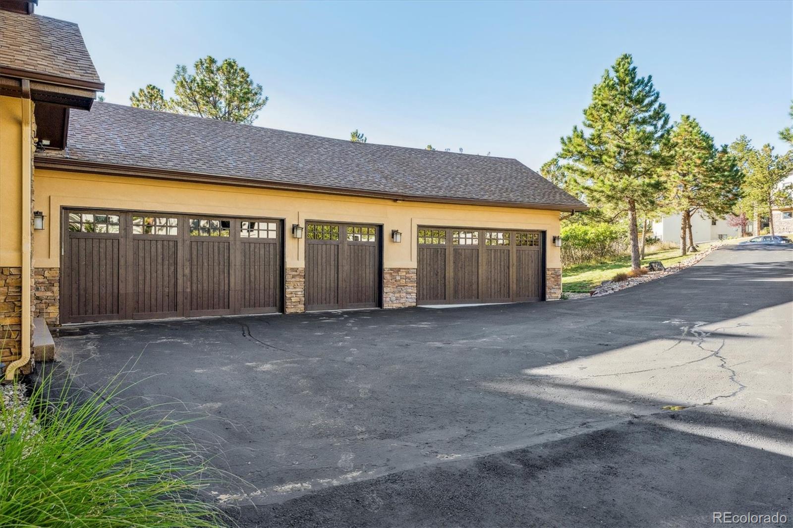 7994 Monarch Road Larkspur, CO 80118 - Photo 2 of 48 a view of a house with a garage and a yard