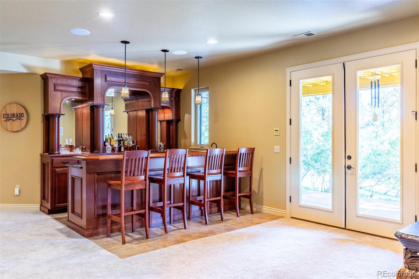 7994 Monarch Road Larkspur, CO 80118 - Photo 22 of 48 a view of a dining room with furniture window and chandelier