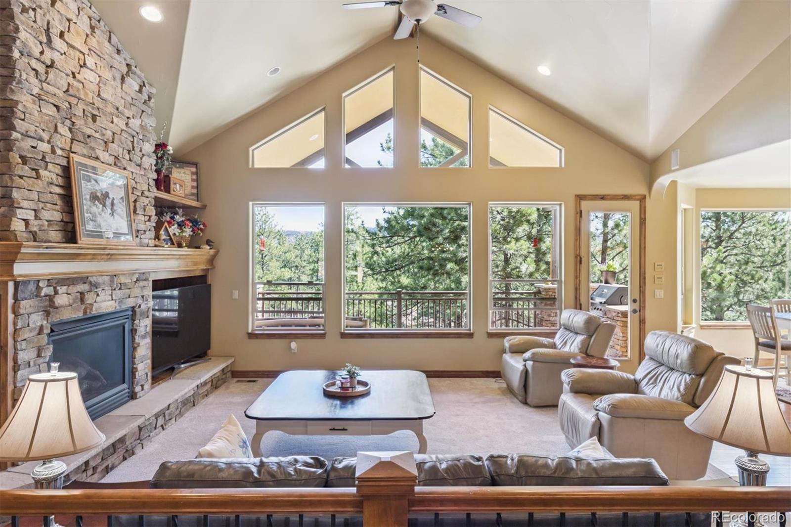 7994 Monarch Road Larkspur, CO 80118 - Photo 3 of 48 a living room with furniture and a fireplace