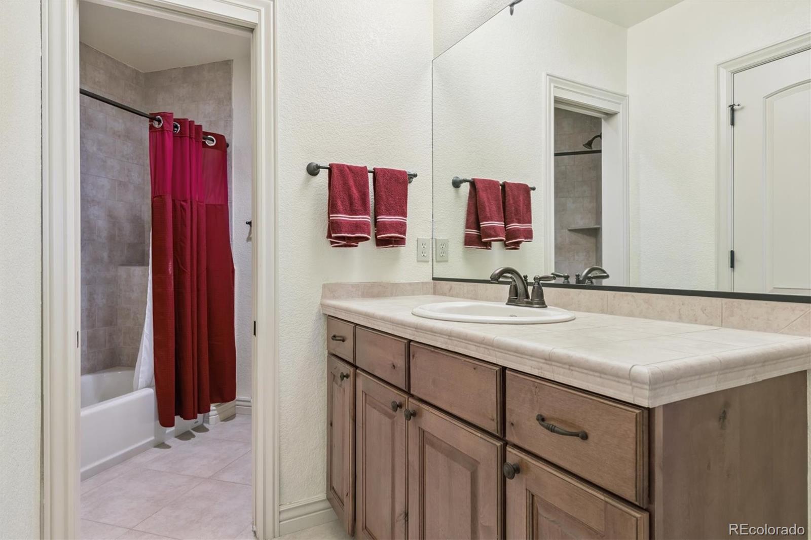 7994 Monarch Road Larkspur, CO 80118 - Photo 31 of 48 a bathroom with a sink vanity and a mirror